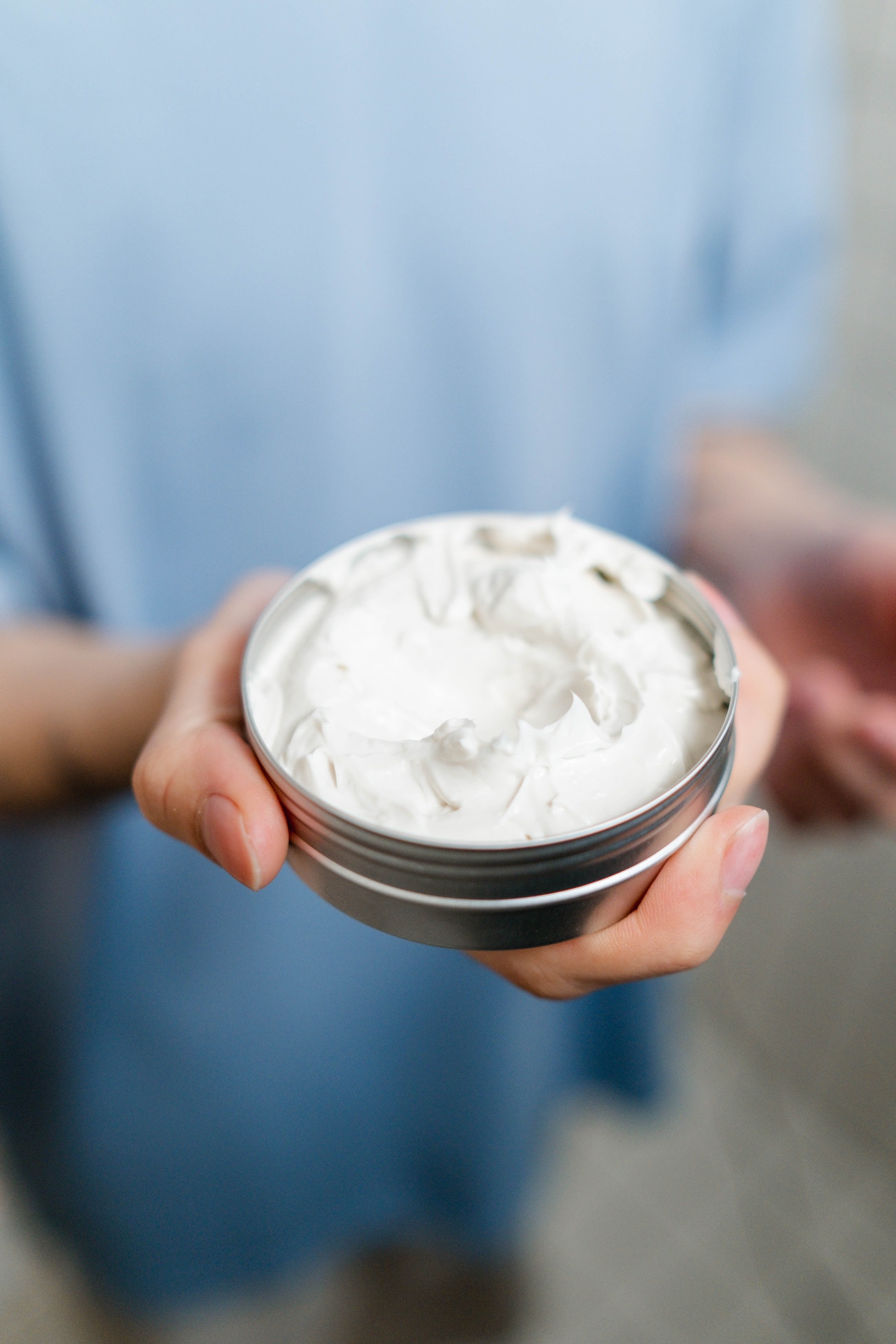 Opened tin of mask, showing white, dense substance