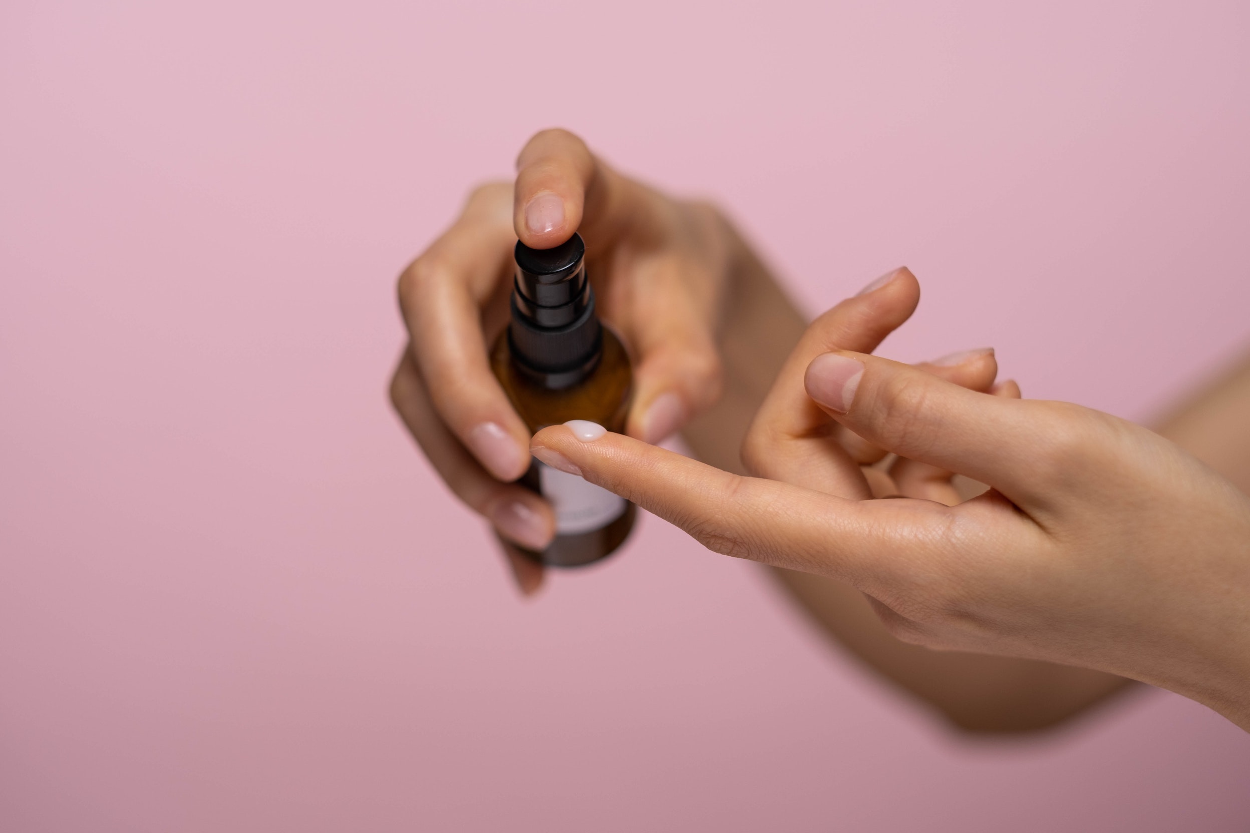 Serum being squeezed onto a woman's finger