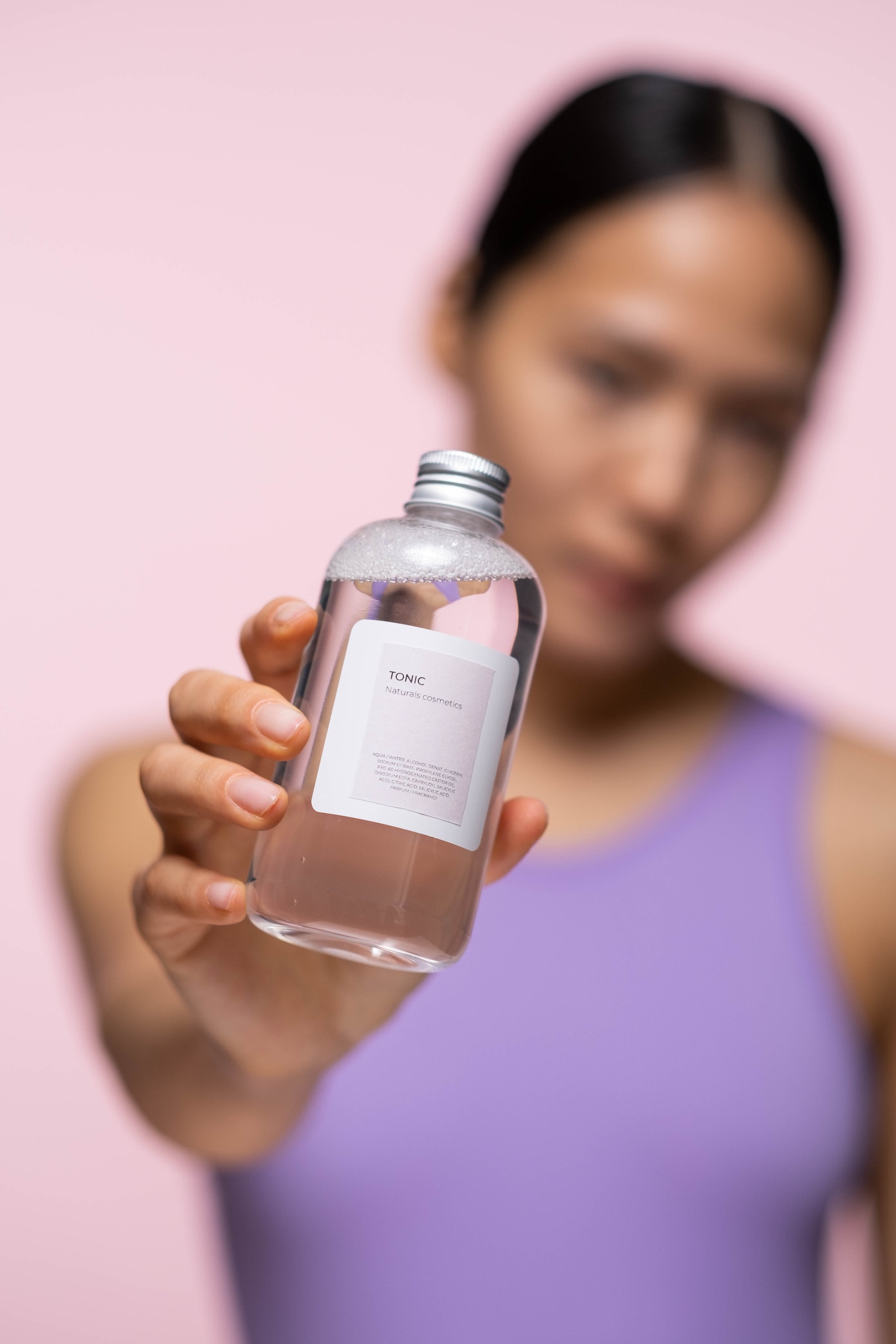 A woman holding the product close up to camera